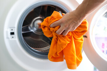 Woman's hand Pick up clothes Washing machine.Clean and Healthy Concepts.