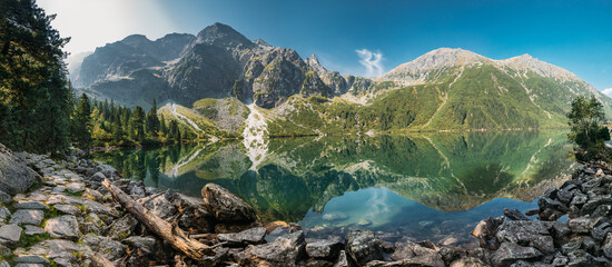 Tatra National Park, Poland. Panorama Famous Mountains Lake Morskie Oko Or Sea Eye Lake In Summer Morning. Five Lakes Valley. Beautiful Scenic View. European Nature © Great Brut Here