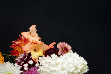 Early fall flower bouquet with gladiolus, hydrangea, zinnia, and dahlia blooms on black background