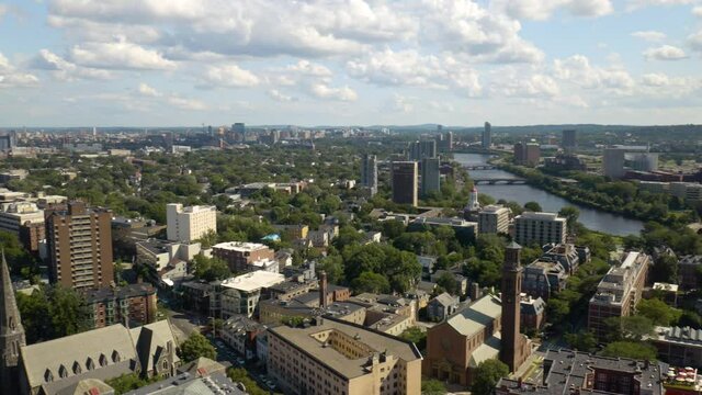 Aerial Pan Left Above Cambridge, Massachusetts with Boston Skyline in Background on Beautiful Summer Afternoon