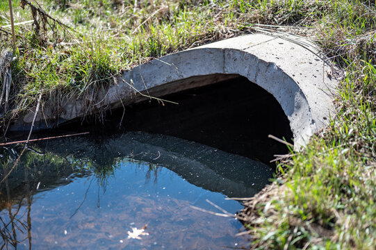 full capacity concrete culvert with sheen contaminated storm water runoff