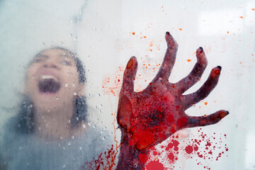 Screaming woman haunted by bloody hand - obrazy, fototapety, plakaty