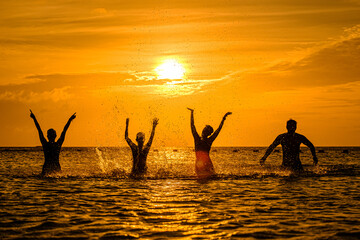 silhouettes of people on the sea, warm sunshine on the morning, at Haadrin beach, koh phangan, surathhani , thailand