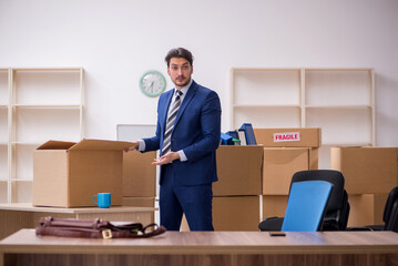 Young male employee in relocation concept