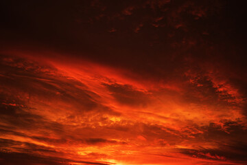 Red sky with clouds. Fiery red sunset background with copy space for design. Horror, cataclysm,...