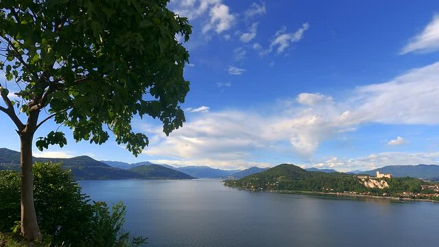 Stunning time-lapse of Maggiore lake with Angera castle and Alps mountain range in background, Italy