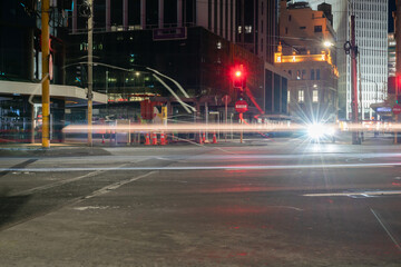 Motion effects of light streams from passing traffic in urban street with lens flare