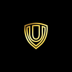 Gold shield with elegant letter u. Letter shield logo design concept template