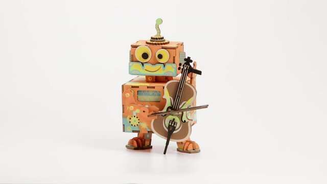 Little Performer Playing Violin Toy. DIY Music Box With Hand Crank. studio shot