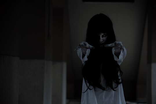 Horror woman ghost creepy standing show 2 hands at the house, halloween day concept
