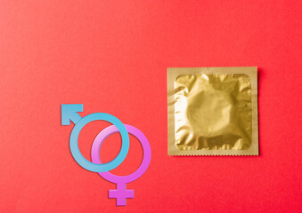 World sexual health or Aids day, Top view flat lay Male, female gender signs condom in wrapper...