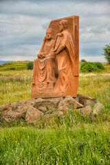 Fototapeta premium Statue in a field, sky on background