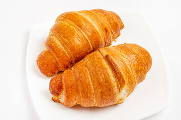 Fresh tasty croissants on white background.