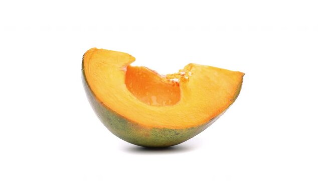 Lucuma slice rotating on white background.
