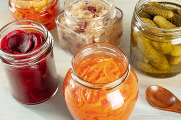 Fototapeta na wymiar Fermented food. Canned vegetables. Pickled carrot, beet, sour cabbage and other organic preserves in mason jars. Healthy vegan cooking