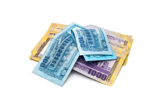 A pile of thousand and hundred taka bangladesh banknotes on an isolated white background