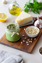 Italian pesto sauce on a wooden background. National kitchen. Healthy eating. Vegetarian food.