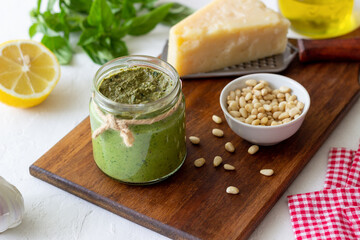 Italian pesto sauce on a wooden background. National kitchen. Healthy eating. Vegetarian food.