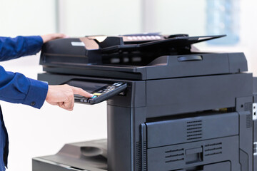 Businessman press button on panel of printer photocopier  network , Working on photocopies in the office concept , printer is office worker tool equipment for scanning and copy paper.