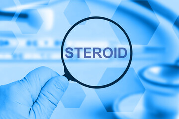 Doctor's hand with a magnifying glass, inscription steroid. Medical concept