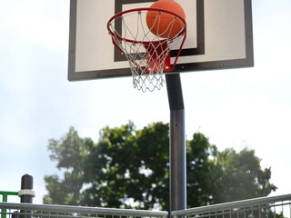 ball flies into the basketball hoop on the street during the game