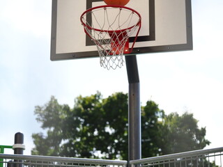 ball flies into the basketball hoop on the street during the game