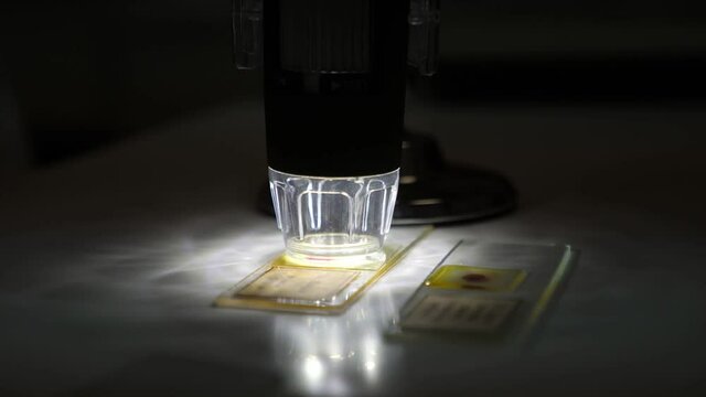 Electron microscope checking and analyzing grain quality analysis in a dark laboratory
