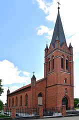 Fototapeta na wymiar General view and architectural details of the Catholic Church of the Exaltation of the Holy Cross built in 1861 in the neo-Gothic style in the city of Olecko in Masuria, Poland.