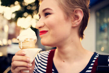 cheerful woman on the street eating ice cream walk summer