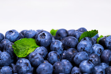 Close up of Blueberry With a Green Mint leaf on a white top view, Summer Freshly Berry, Copyspace