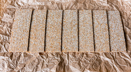 Bread chips with various seeds on paper