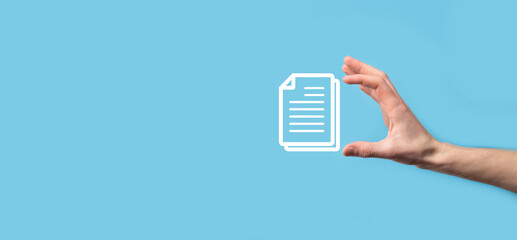 Male hand holding a document icon on blue background. Document Management Data System Business Internet Technology Concept. Corporate data management system DMS