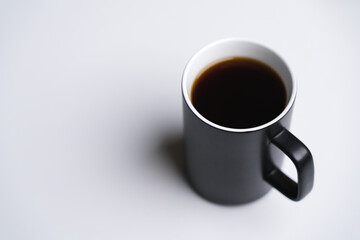 Black ceramic cup of dark coffee drink