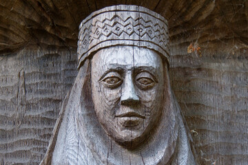 Fototapeta na wymiar A statue of a woman hollowed out in a tree. Handmade 