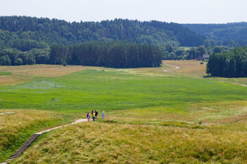 Hilly country. Walking paths up the mountain. Kernavė, site of the ancient city. High hills by the river. Wooden staircase to the mountain. The famous Lithuanian landscape.