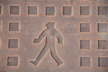 Israeli local Manhole cover at Netanya, Israel. Walking man on manhole metal cover