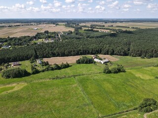 Polish countryside, farm, fields, meadows seen from above - photo drone 