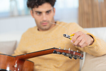 a man changes guitar strings