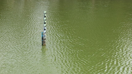 Water level gauge in the pool. The water level gauge is located in the water on the background as the water in the pool. with copy space. Selective focus