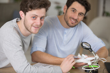 young man learning to fix a drone