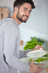 man cooking and cutting veggies for lunch