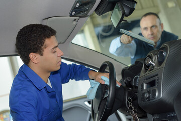 young man cleaning car interior