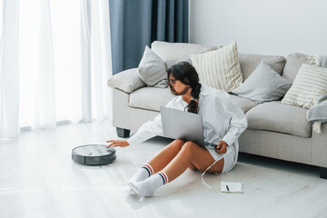 Freelance work. Woman in casual clothes is indoors at home