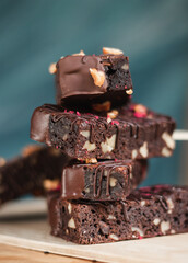 many delicious chocolate brownies with nuts in chocolate on a stick in the summer in a cafe