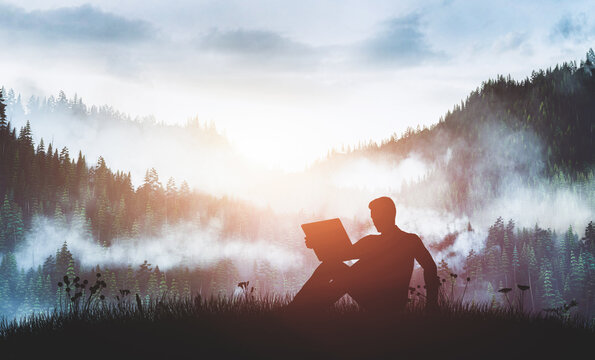Man with laptop on the forest track at sunrise.