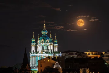 Muurstickers Full Moon Rising over Saint Andrew Church at night in Kyiv, Ukraine © elena_suvorova