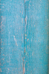 Fototapeta na wymiar Texture of an old board with cracks in a turquoise color.