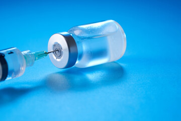 vaccine bottle on the blue background