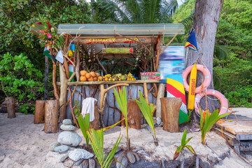 Exotic summer beach bar with mixed fruits coconut, banana and tropical fruits in Seychelles tropical island.