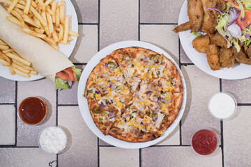 Vegetarian pizza, wrap & fried chicken served with donner meat, chicken tikka and salad – fast...